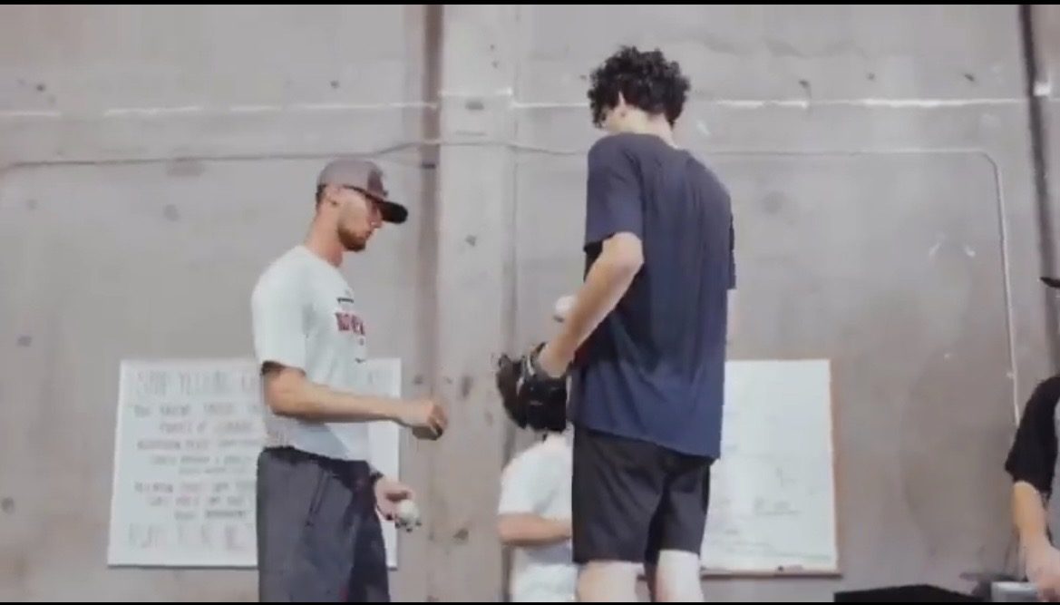 Tommy Sleva coaching pitch grips with an athlete